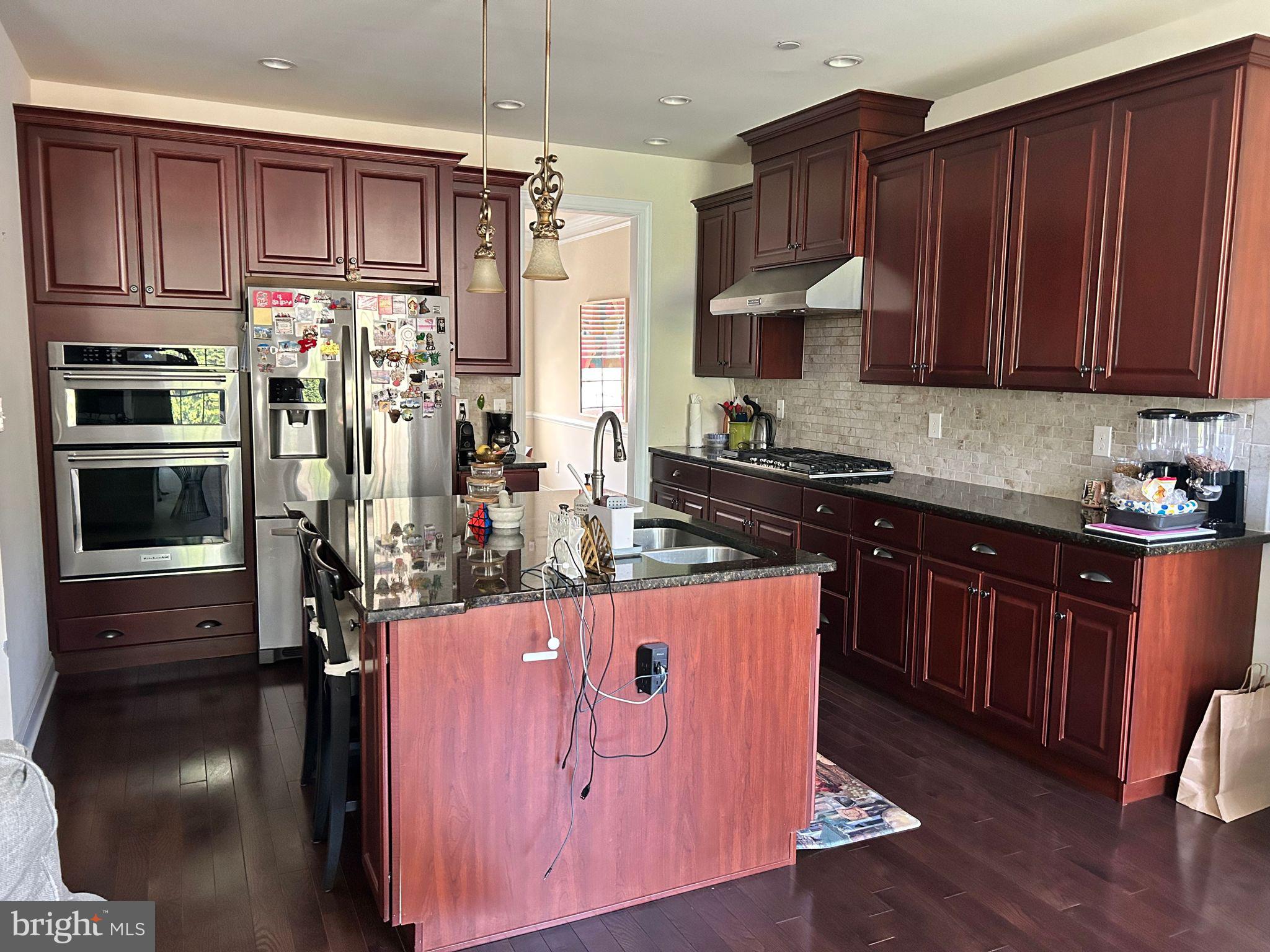 3049 Rainer Road Chester Springs, PA 19425 - Photo 18 of 19 a kitchen with wooden cabinets and stainless steel appliances