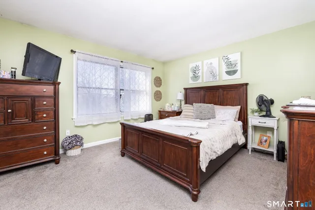 a view of a bedroom with clothes and shoes