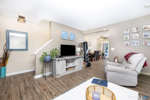 a living room with furniture and wooden floor