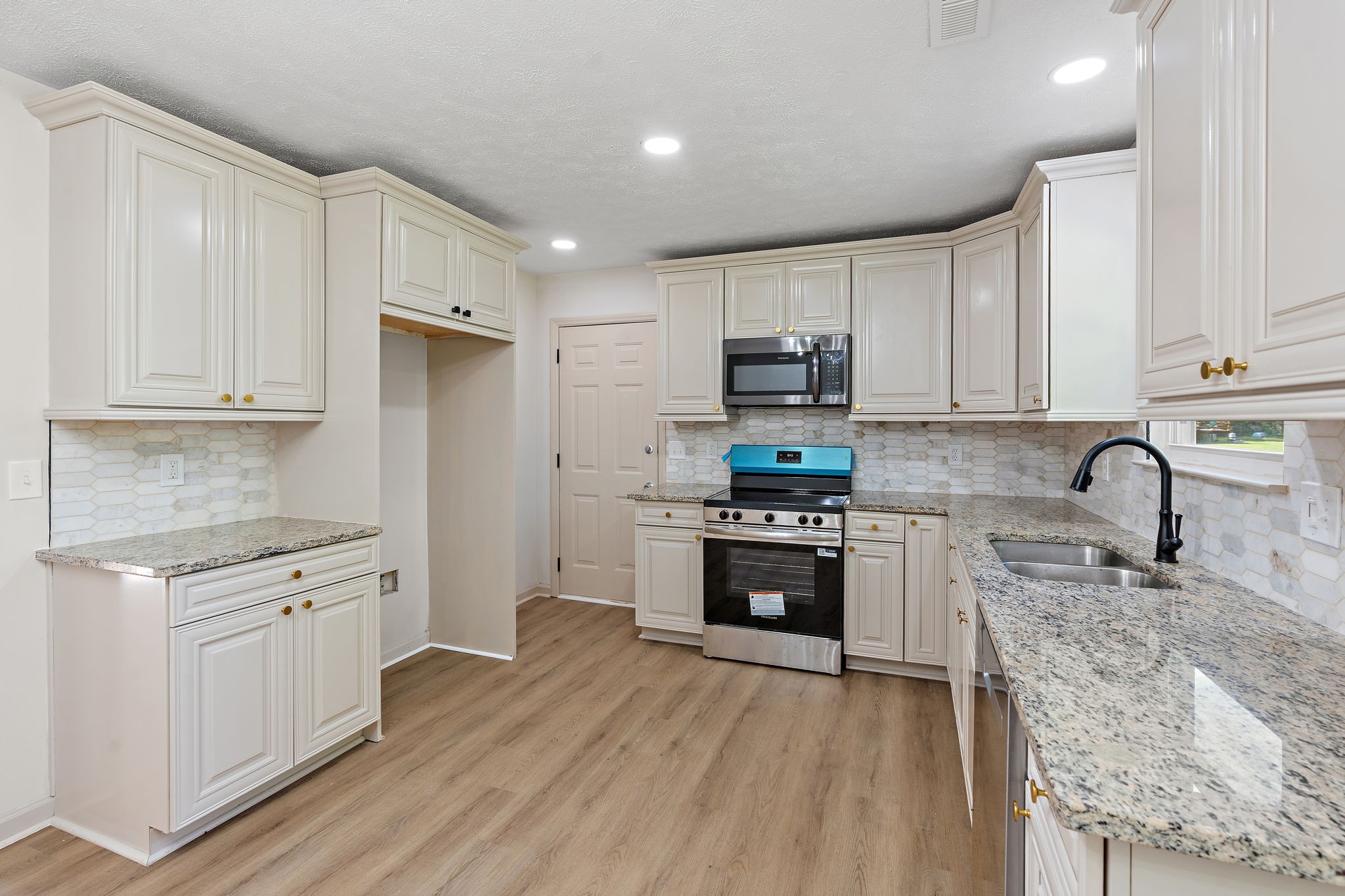 583 Parsons Road Christiana, TN 37037 - Photo 11 of 35 a kitchen with stainless steel appliances granite countertop a stove top oven a sink dishwasher a refrigerator and cabinets with wooden floor