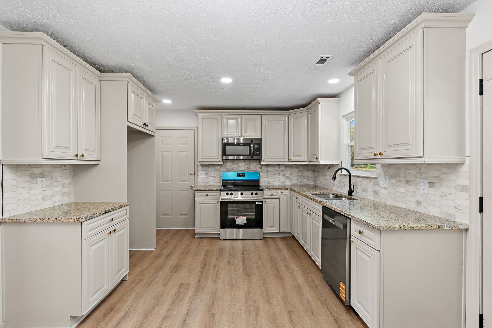 583 Parsons Road Christiana, TN 37037 - Photo 12 of 35 a kitchen with granite countertop a sink a counter top space stainless steel appliances and cabinets