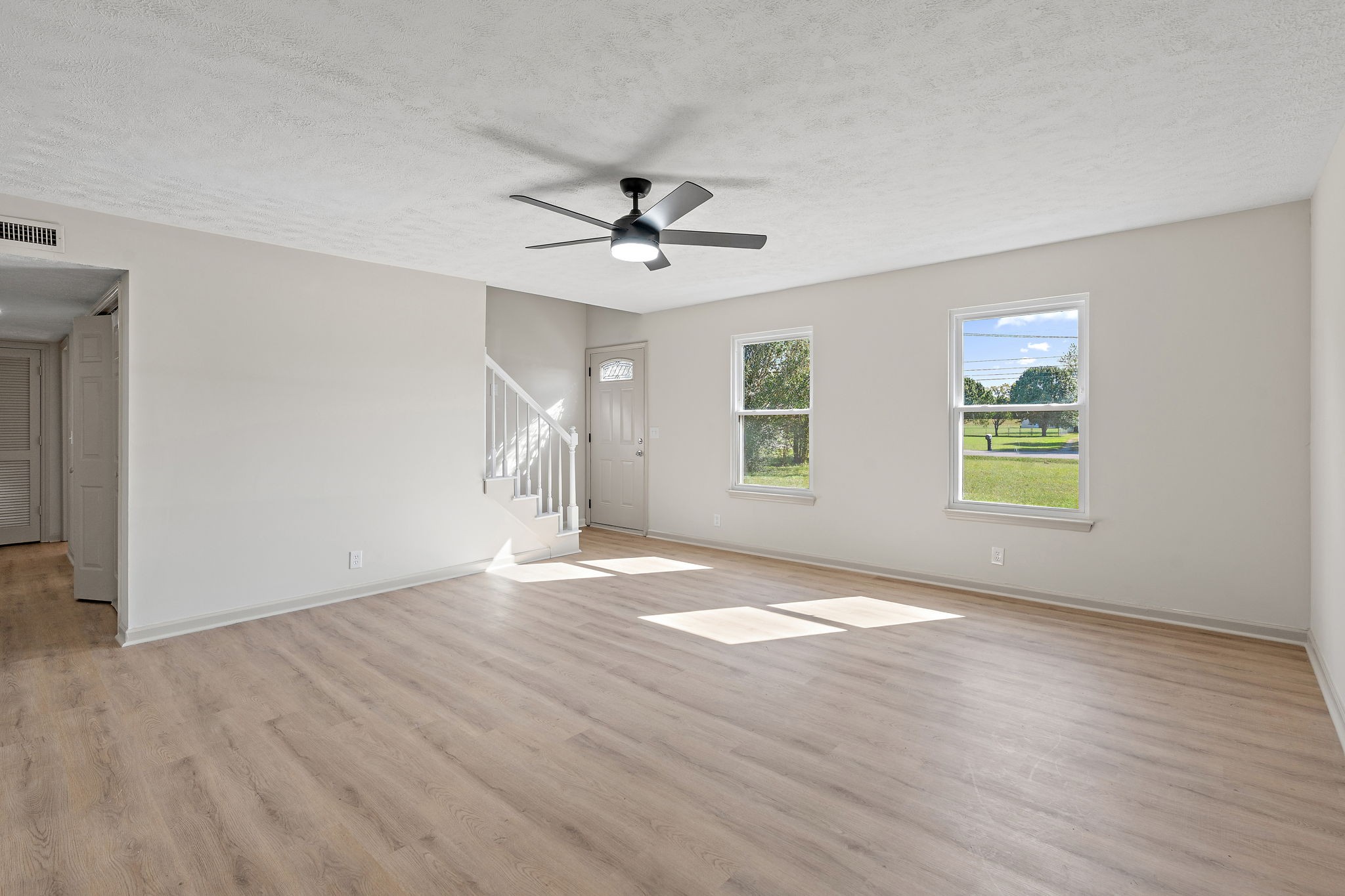 583 Parsons Road Christiana, TN 37037 - Photo 6 of 35 a view of an empty room with wooden floor and a window