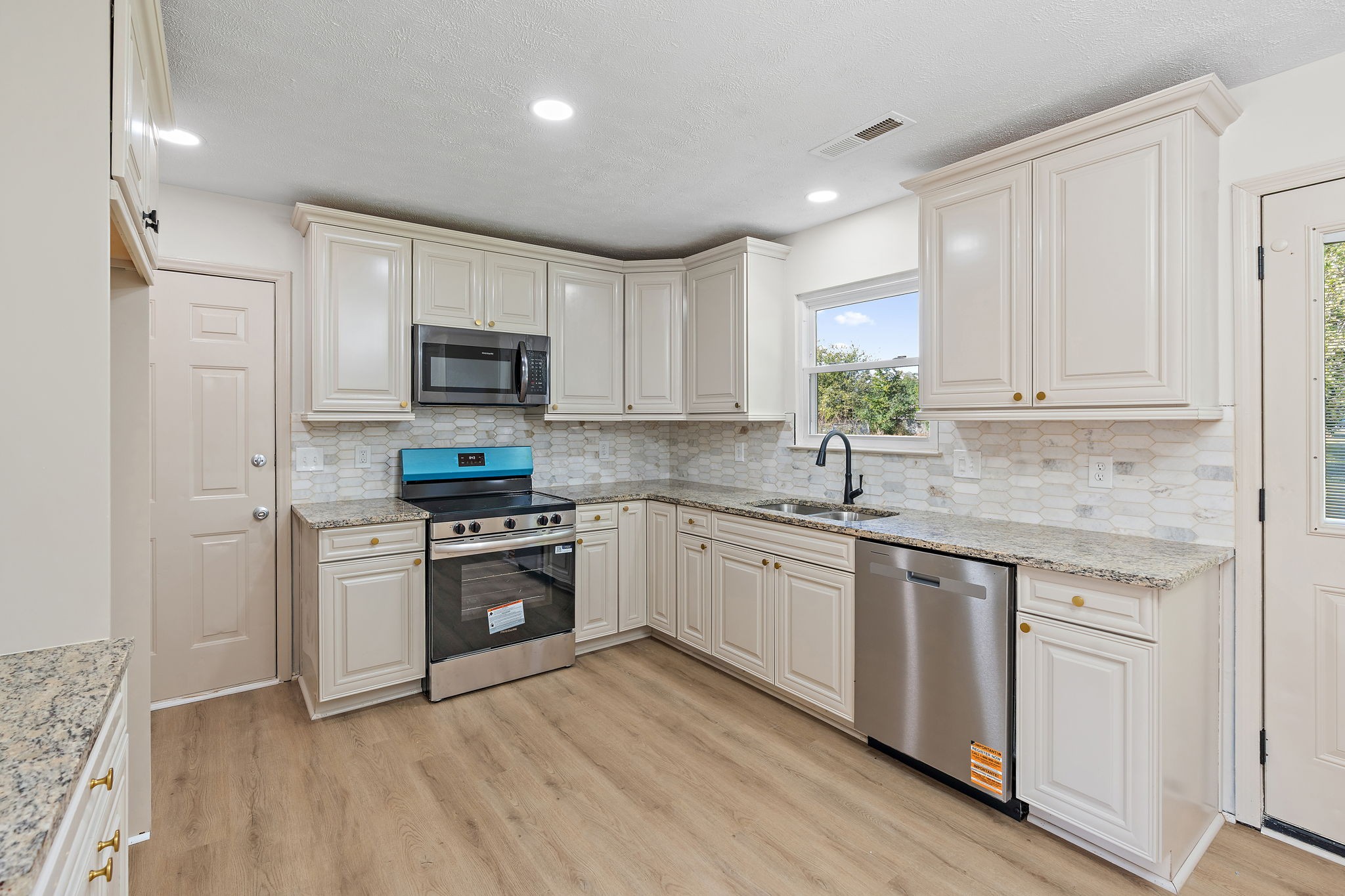 583 Parsons Road Christiana, TN 37037 - Photo 10 of 35 a kitchen with granite countertop white cabinets and stainless steel appliances