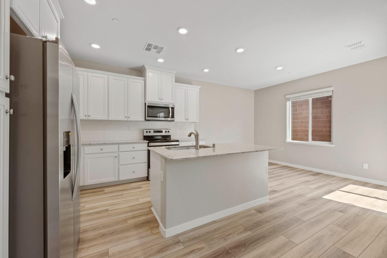 2948 Pulp Ml Lane Lincoln, CA 95648 - Photo 7 of 23 a kitchen with white cabinets and appliances