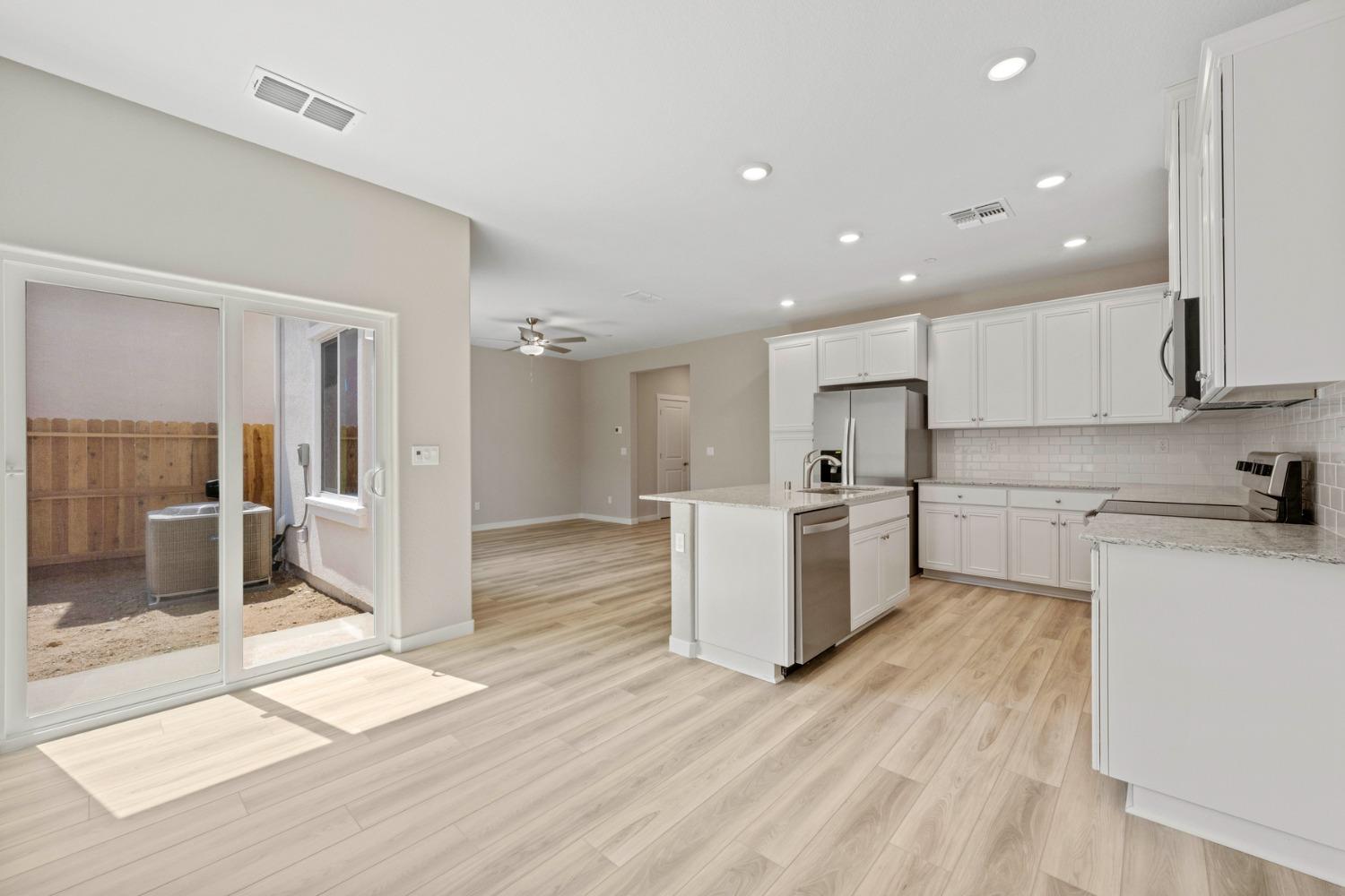 2948 Pulp Ml Lane Lincoln, CA 95648 - Photo 9 of 23 a large kitchen with a large counter top a sink stainless steel appliances and cabinets