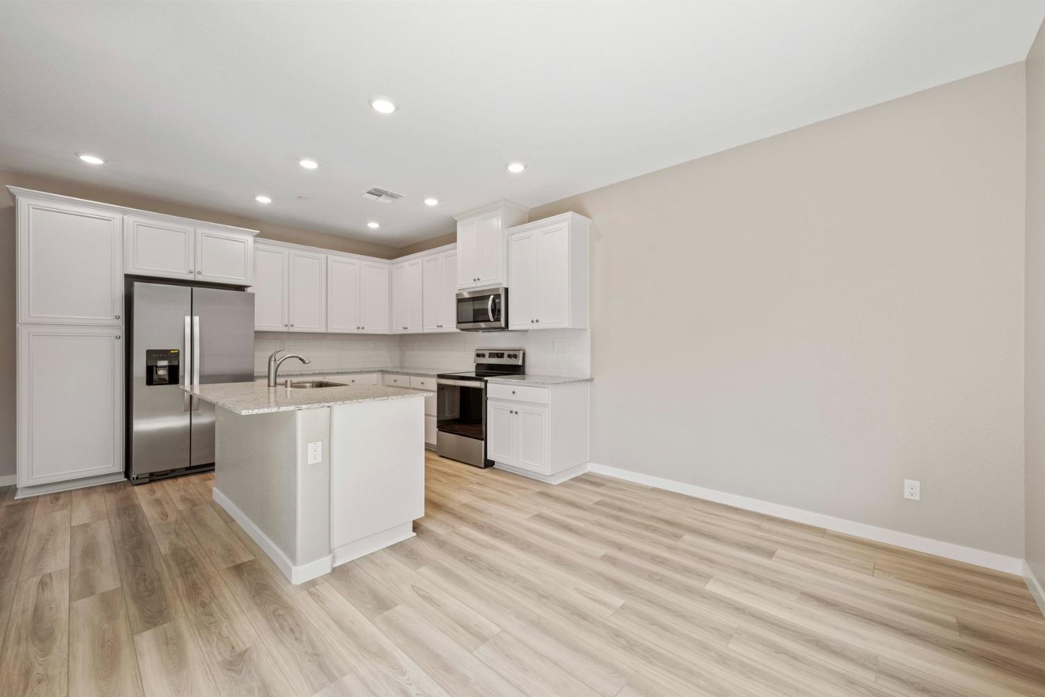 2948 Pulp Ml Lane Lincoln, CA 95648 - Photo 10 of 23 a kitchen with white cabinets and stainless steel appliances