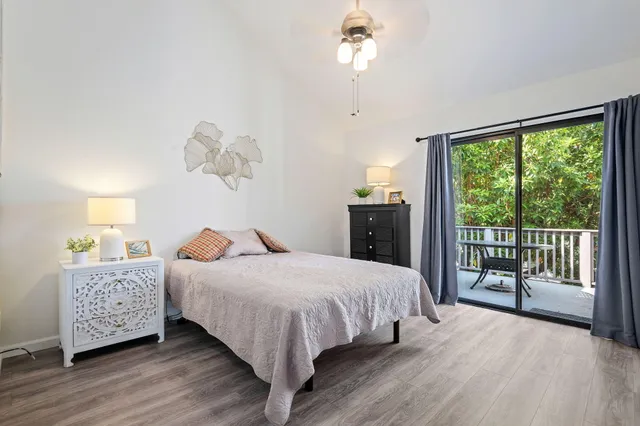 a bedroom with a large bed and a chandelier