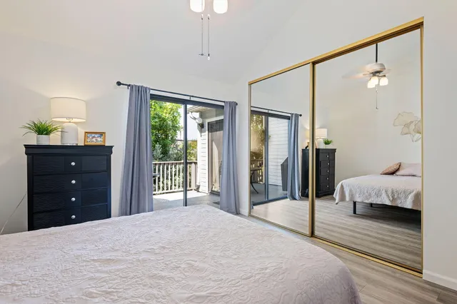 a bedroom with a bed window and a dresser