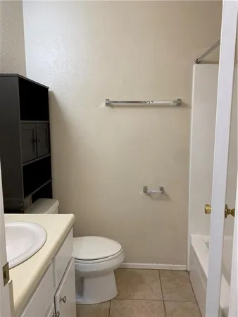 a bathroom with a toilet a sink and shower