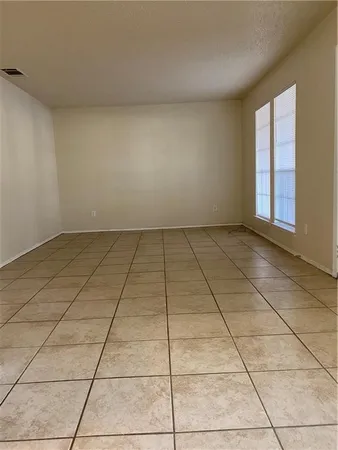 a view of a livingroom with an empty space and window