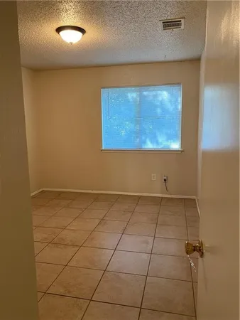 a view of a room with a projector and cabinets