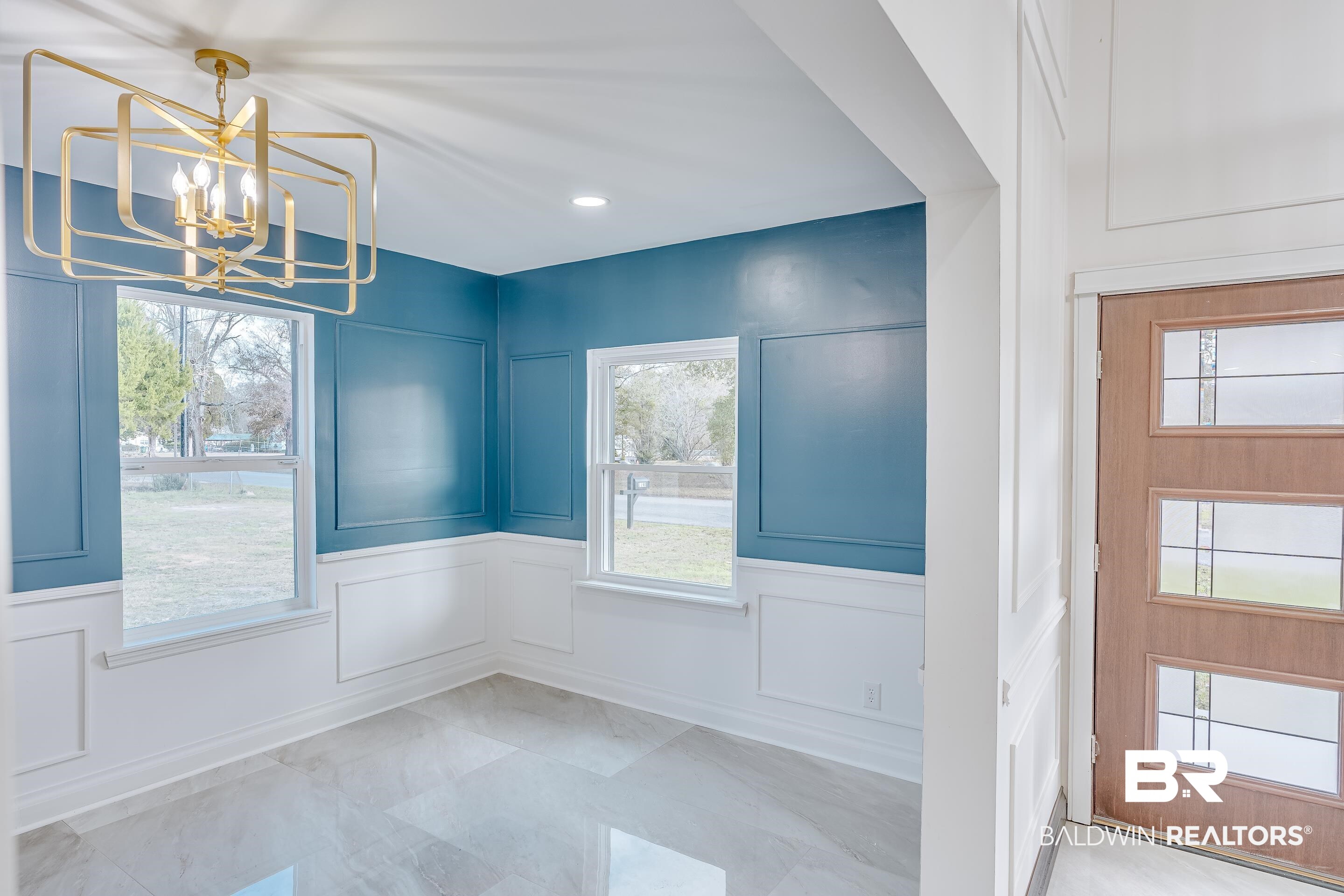 1190 Military Road Mount Vernon, AL 36560 - Photo 14 of 47 Unfurnished dining area with a decorative wall, plenty of natural light, a chandelier, and light marble finish flooring