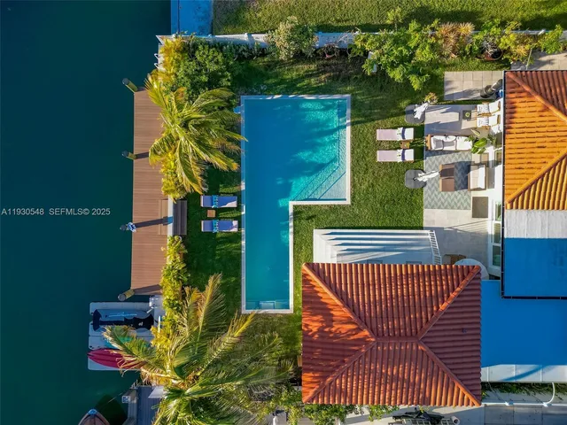 an aerial view of a house with swimming pool and outdoor space