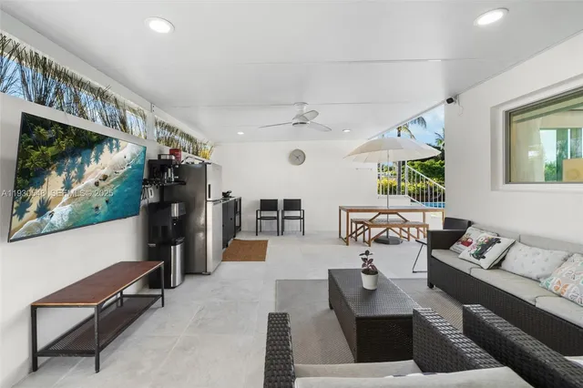 a view of a lake with a floor to ceiling window next to a yard