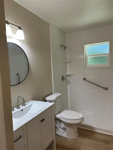 a white toilet sitting next to a bathroom sink