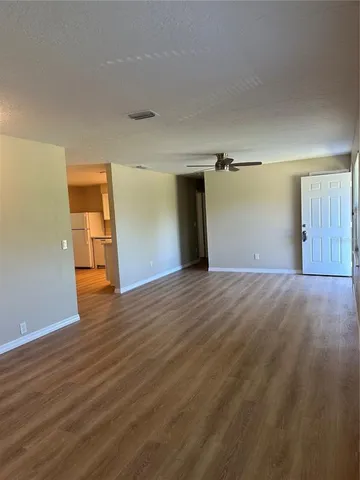 a view of a room with wooden floor and walls