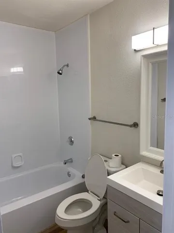 a bathroom with a sink a toilet and a bathtub