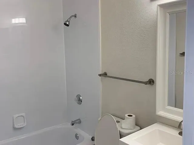 a bathroom with a bathtub and shower