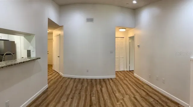 a view of a room with wooden floor