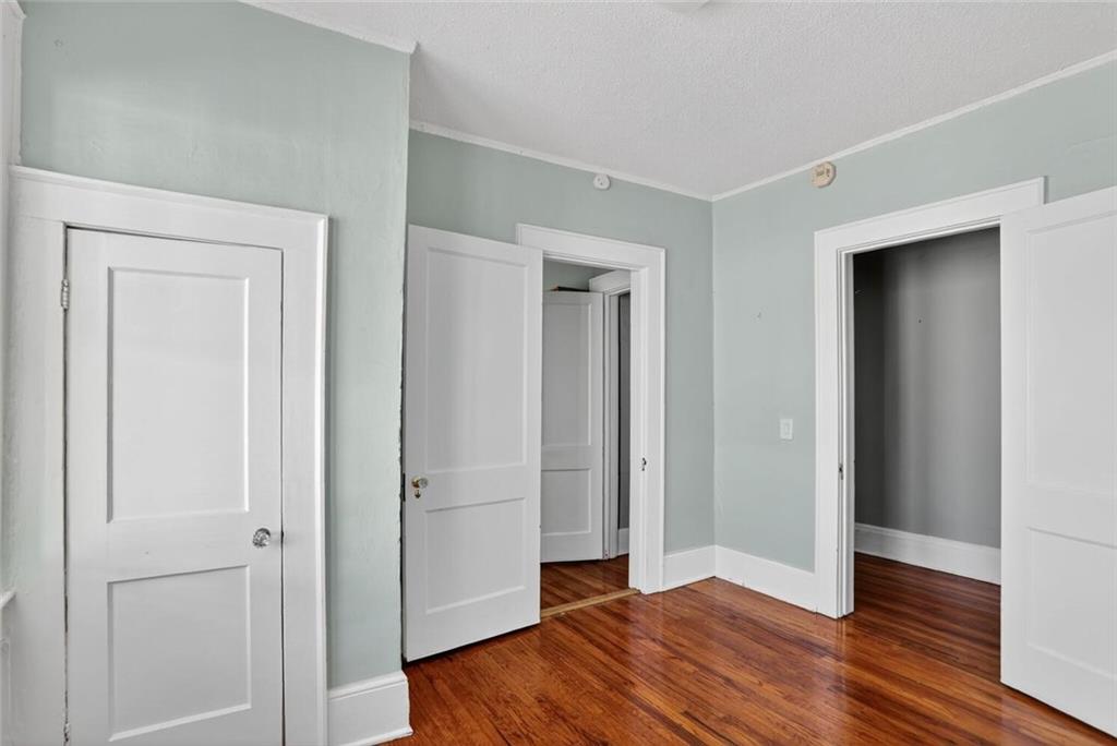 1497 North Morningside Drive Northeast Atlanta, GA 30306 - Photo 13 of 36 an empty room with wooden floor & closet area