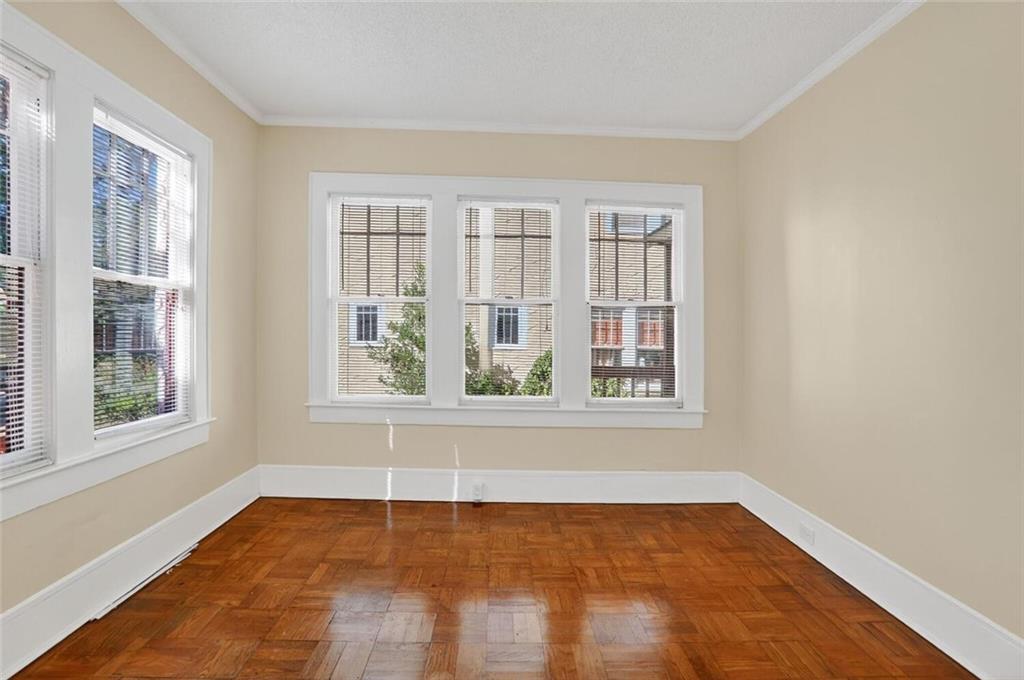 1497 North Morningside Drive Northeast Atlanta, GA 30306 - Photo 19 of 36 an empty room with wooden floor and windows