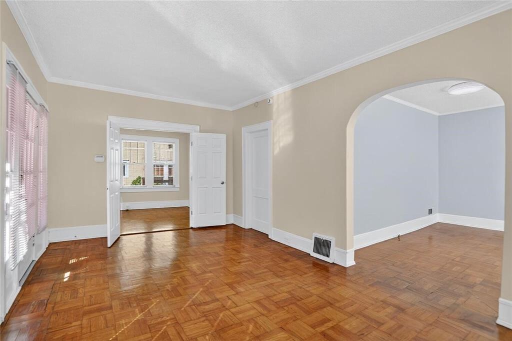 1497 North Morningside Drive Northeast Atlanta, GA 30306 - Photo 20 of 36 a view of an empty room with wooden floor and a window