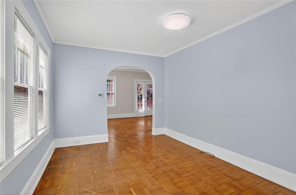 1497 North Morningside Drive Northeast Atlanta, GA 30306 - Photo 22 of 36 an empty room with wooden floor and windows