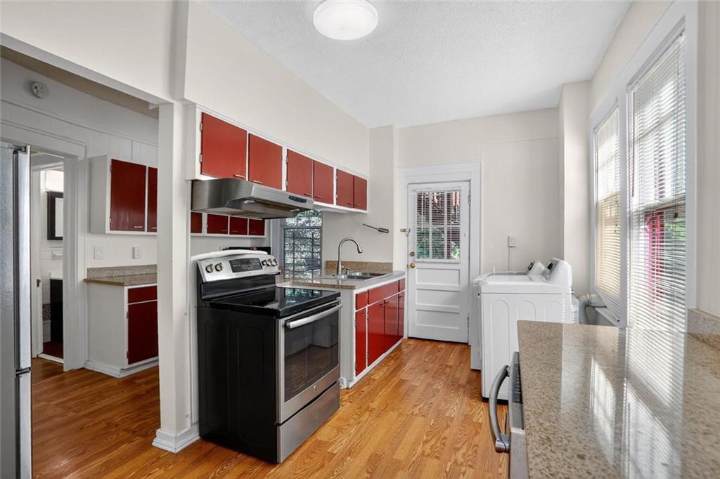 1497 North Morningside Drive Northeast Atlanta, GA 30306 - Photo 23 of 36 a kitchen with stainless steel appliances granite countertop a stove and a refrigerator