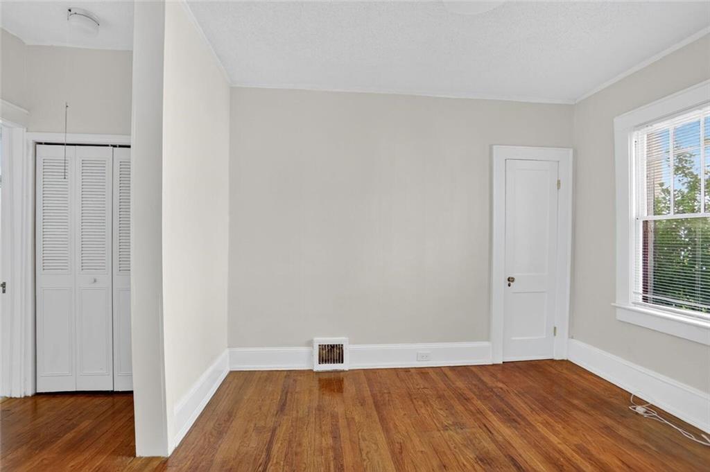 1497 North Morningside Drive Northeast Atlanta, GA 30306 - Photo 25 of 36 an empty room with wooden floor and windows
