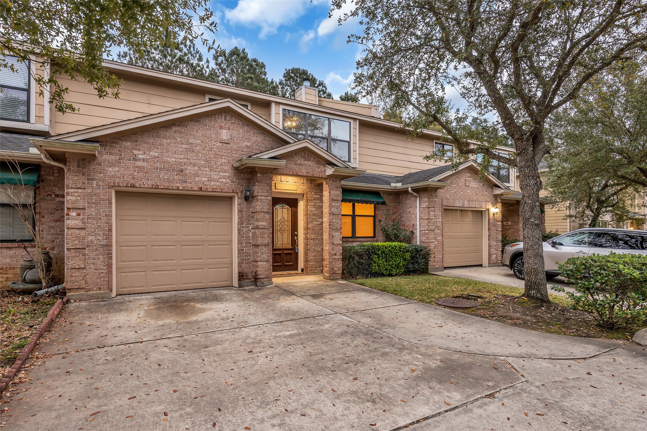 1898 Longmire Road, Unit 5 Conroe, TX 77304 - Photo 42 of 48 This charming townhouse features a brick facade with a welcoming front entrance and attached garage. It has a well-maintained front yard with mature trees and a spacious driveway. Ideal for buyers seeking a cozy, low-maintenance home in a serene neighborhood.