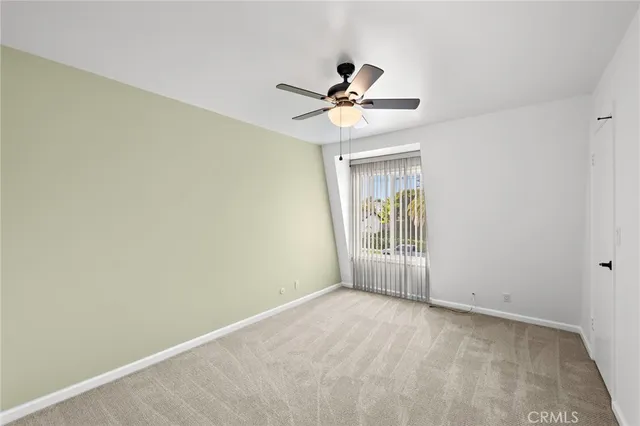 a view of room with window and ceiling fan