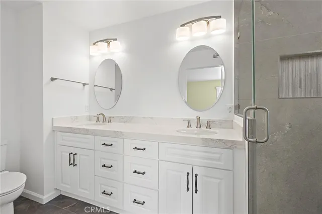 a bathroom with a double vanity sink and a mirror
