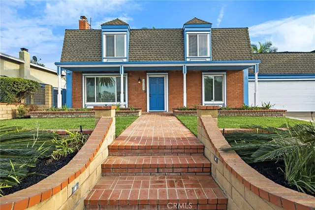 a view of a brick building next to a yard