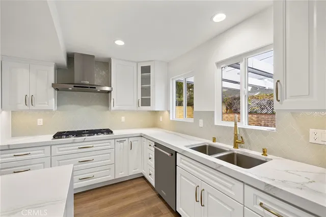 a kitchen with a stove a sink and a refrigerator