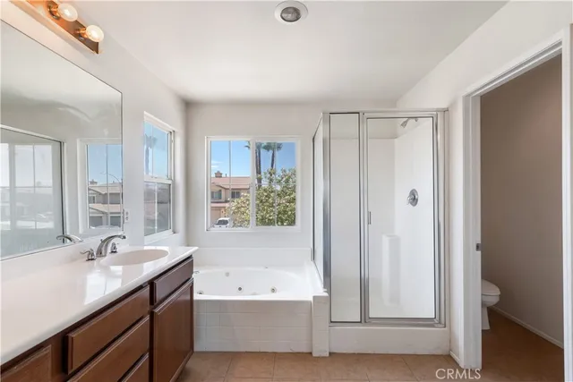 a bathroom with a tub a sink and a large mirror