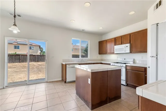 a kitchen with stainless steel appliances granite countertop a stove and a refrigerator