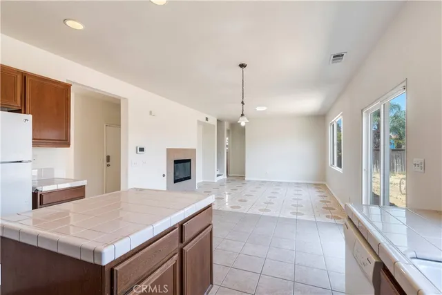 a large kitchen with kitchen island a sink stainless steel appliances and cabinets