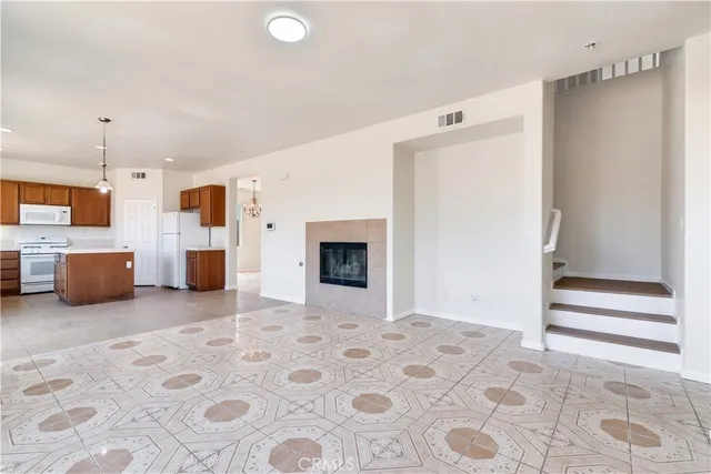 a view of a livingroom with kitchen and furniture