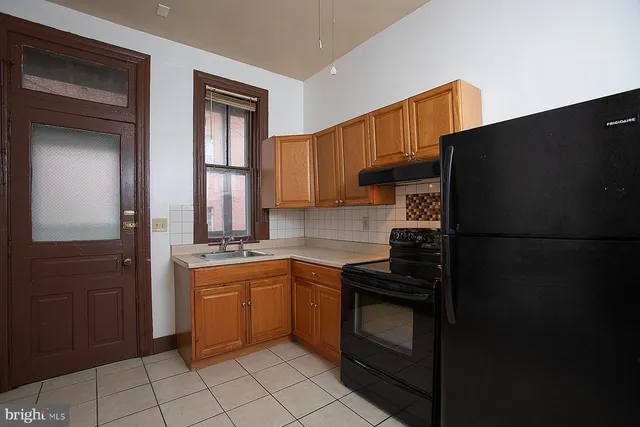a kitchen with a sink appliances and cabinets