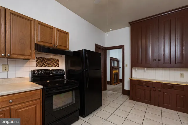 a kitchen with a refrigerator stove and cabinets