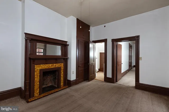 a view of an empty room with a fireplace