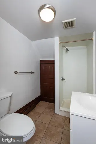 a bathroom with a toilet and a mirror
