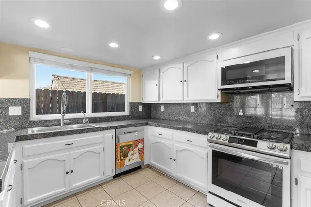 a kitchen with a stove sink and microwave