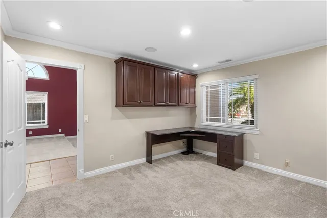 an empty room with windows cabinet and balcony