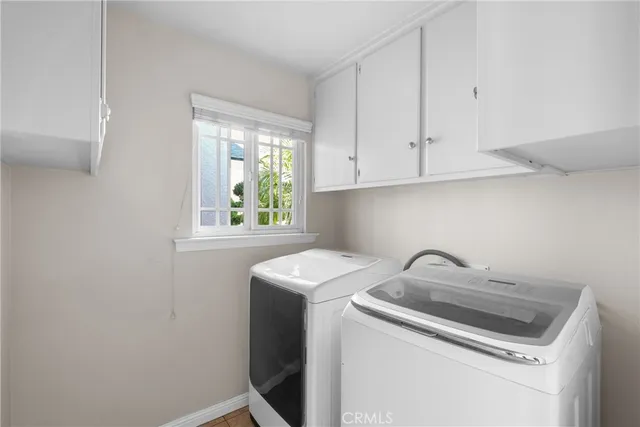 an empty room with windows and ceiling fan