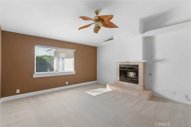 a view of empty room with a fireplace