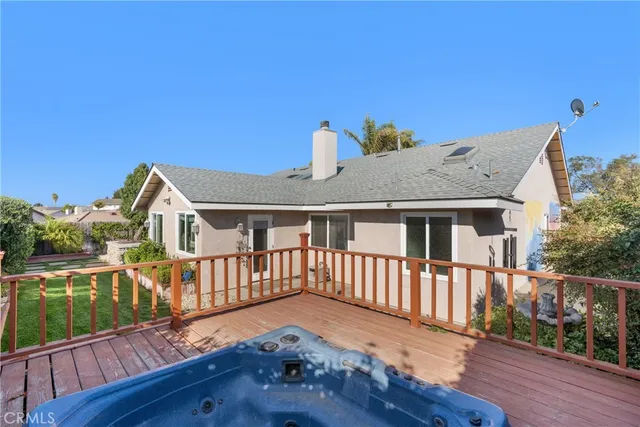 a view of house with a big yard and potted plants