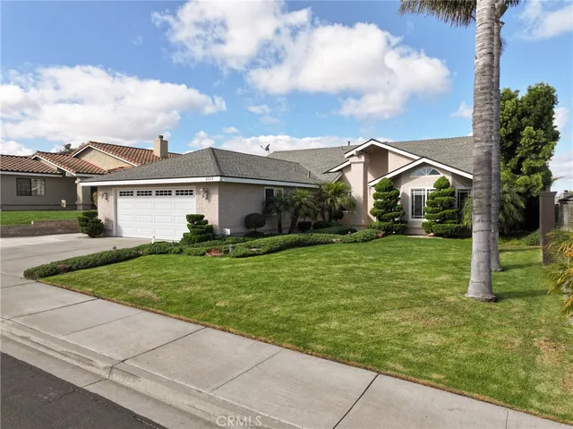 a front view of house with yard and green space