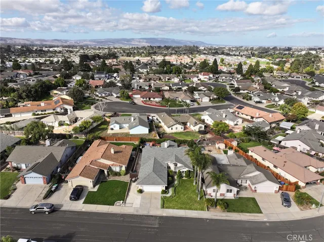 an aerial view of residential houses with city view