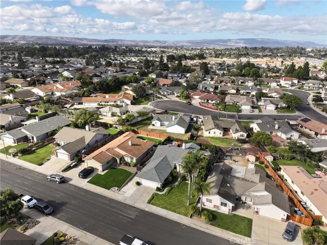 an aerial view of a house with garden space and street view